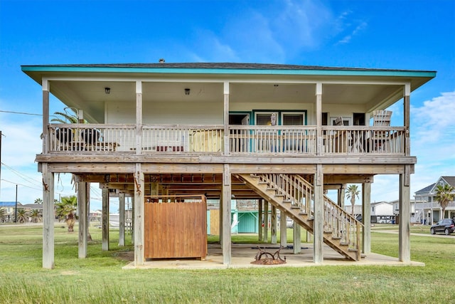 back of house featuring a deck and a yard