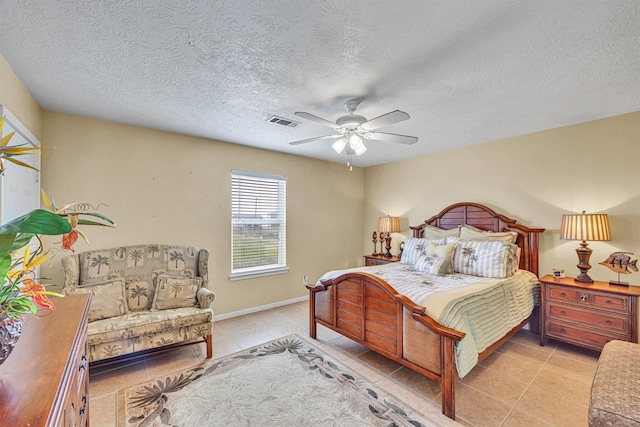 818 Sea Shell Dr, Freeport, TX 77541 - bedroom featuring ceiling fan, light tile patterned floors, and a textured ceiling