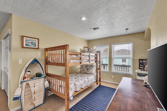818 Sea Shell Dr, Freeport, TX 77541 - tiled bedroom with a textured ceiling