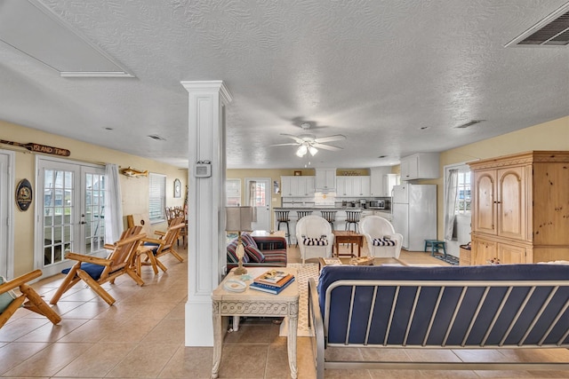 818 Sea Shell Dr, Freeport, TX 77541 - tiled living room featuring plenty of natural light and a textured ceiling
