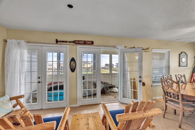 818 Sea Shell Dr, Freeport, TX 77541 - doorway to outside featuring ceiling fan, french doors, light tile patterned floors, and a textured ceiling