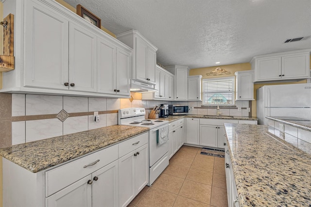 818 Sea Shell Dr, Freeport, TX 77541 - kitchen with decorative backsplash, a textured ceiling, white appliances, sink, and white cabinetry
