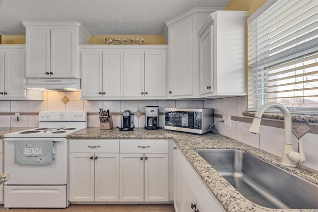818 Sea Shell Dr, Freeport, TX 77541 - kitchen featuring sink, light stone countertops, tasteful backsplash, white range with electric stovetop, and white cabinetry