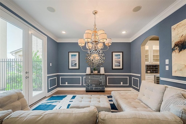 living room with light wood-type flooring, plenty of natural light, and crown molding