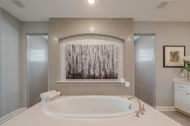 bathroom with a washtub and vanity