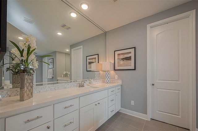 bathroom with tile patterned floors and vanity