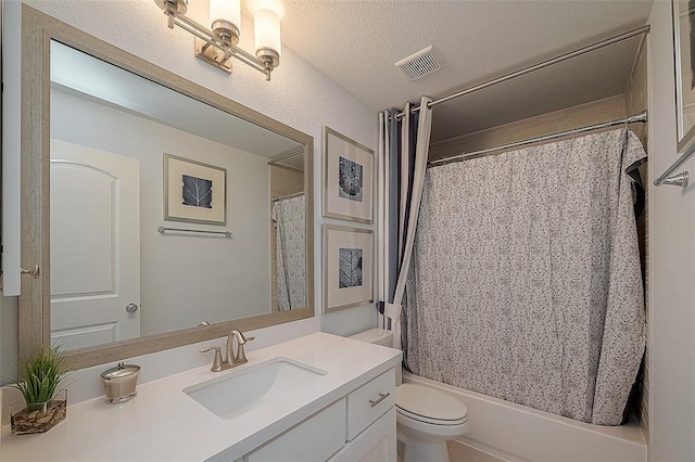 full bathroom featuring shower / tub combo with curtain, vanity, a textured ceiling, and toilet