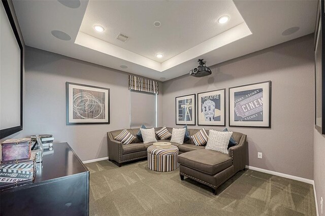 home theater featuring carpet flooring and a tray ceiling