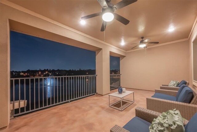 patio at night featuring an outdoor living space and a balcony