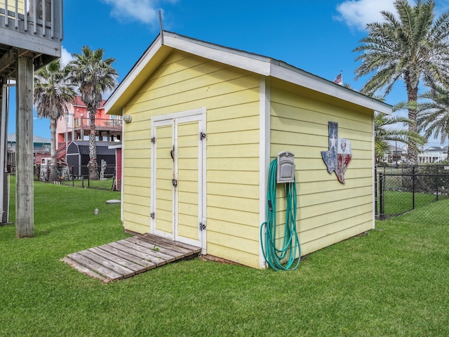 view of outbuilding with a yard