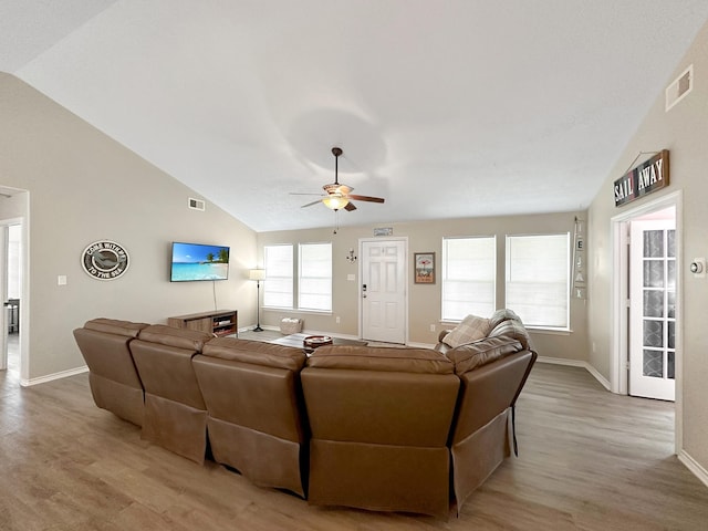 living room featuring light wood-type flooring, ceiling fan, and lofted ceiling