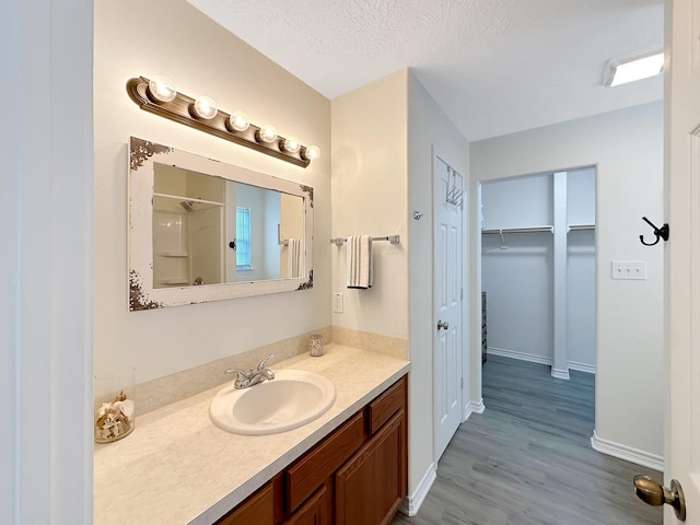 bathroom featuring vanity, a textured ceiling, and hardwood / wood-style flooring