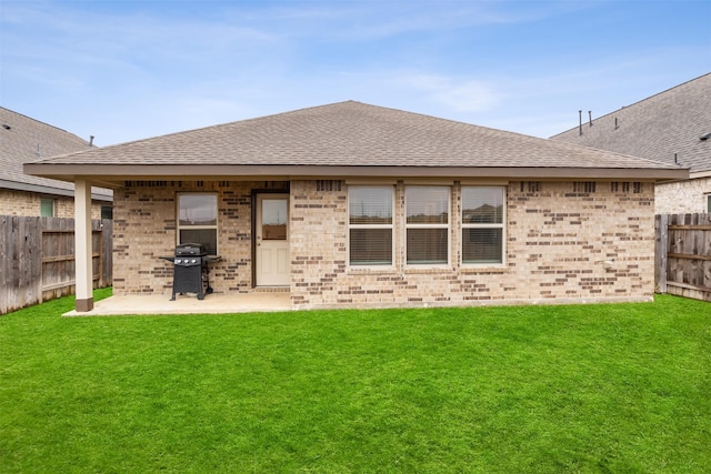 rear view of house featuring a patio area and a yard