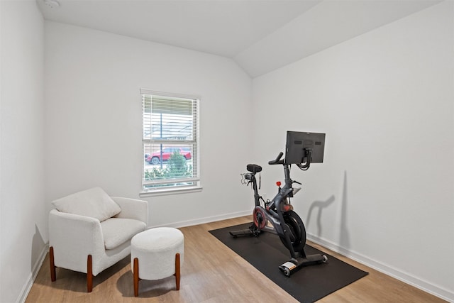 workout area with vaulted ceiling and hardwood / wood-style flooring