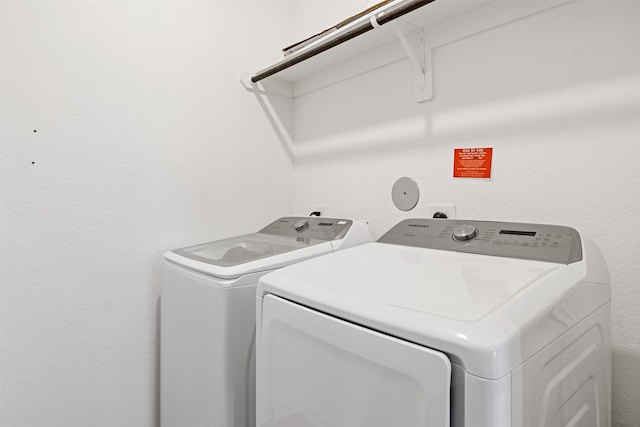 clothes washing area featuring washing machine and clothes dryer