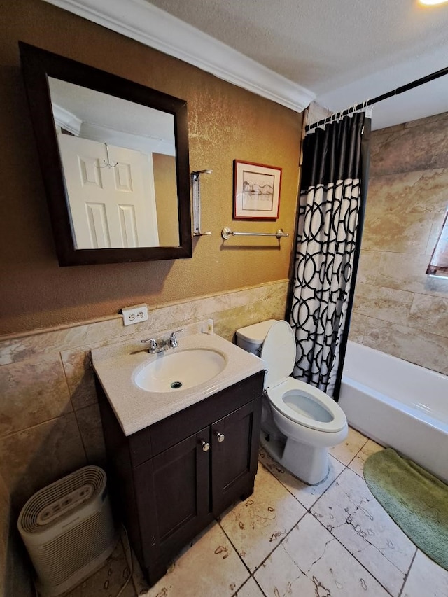 full bathroom with vanity, a textured ceiling, crown molding, shower / bath combo with shower curtain, and toilet