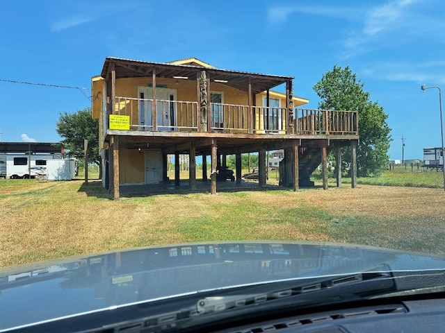 rear view of property featuring a lawn