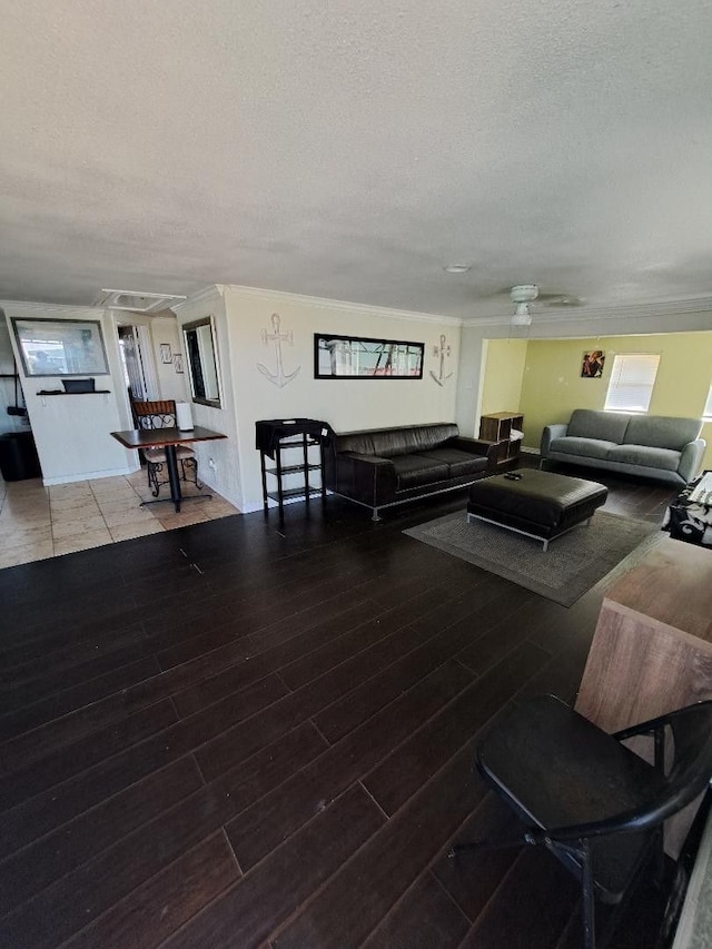 living room with ceiling fan and a textured ceiling