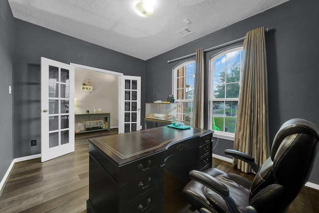 home office featuring dark hardwood / wood-style flooring, french doors, and a healthy amount of sunlight