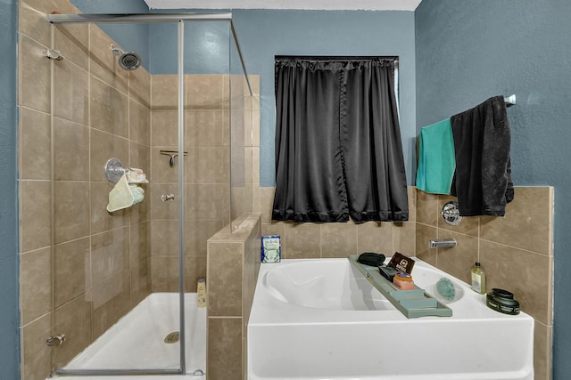 bathroom featuring separate shower and tub