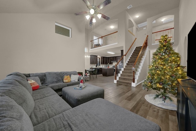 living room featuring ceiling fan, high vaulted ceiling, and dark hardwood / wood-style floors