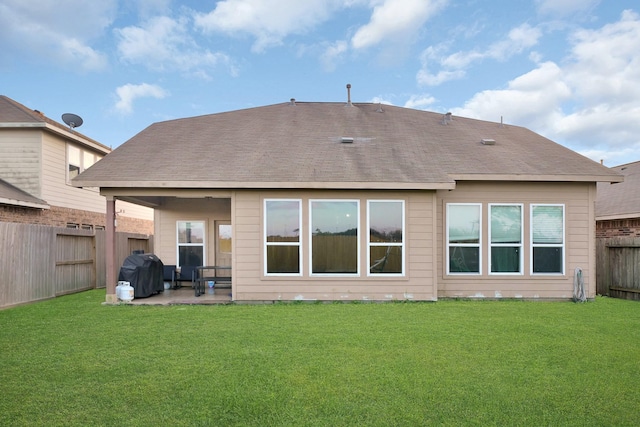 back of house featuring a yard and a patio area