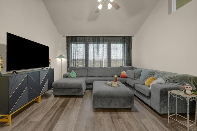 living room featuring hardwood / wood-style floors, ceiling fan, and high vaulted ceiling