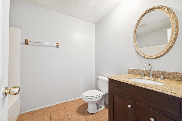 bathroom featuring tile patterned flooring, vanity, toilet, and a textured ceiling