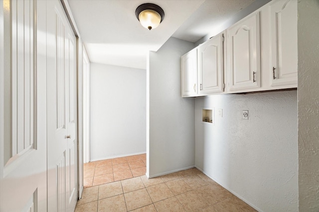 laundry room featuring washer hookup, light tile patterned floors, cabinets, and hookup for an electric dryer