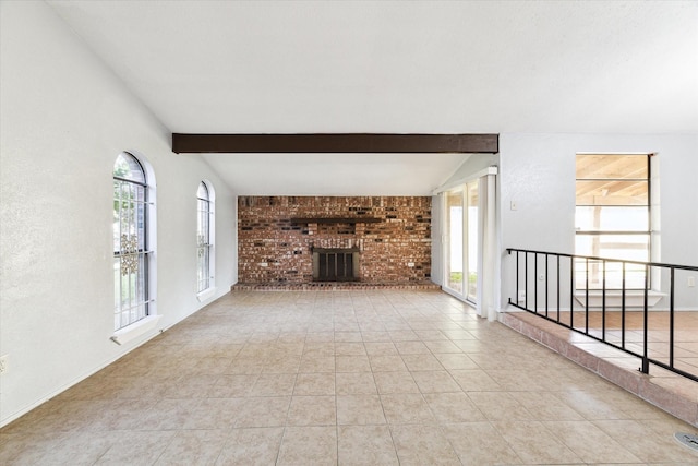 unfurnished living room featuring beam ceiling, light tile patterned floors, and a brick fireplace