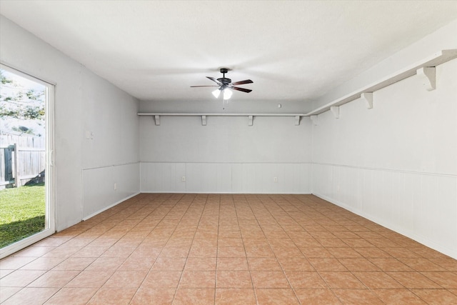 spare room featuring ceiling fan and a healthy amount of sunlight