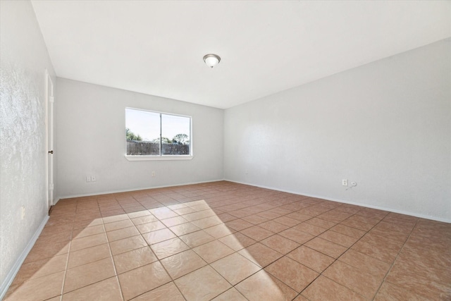 unfurnished room featuring light tile patterned floors