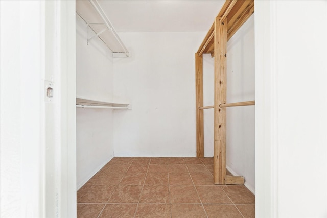 spacious closet featuring light tile patterned floors