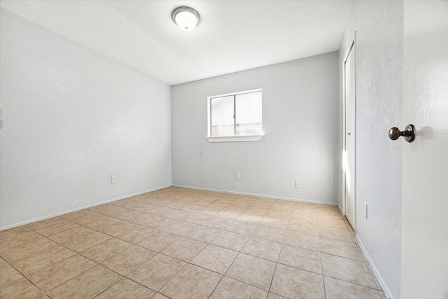 spare room with light tile patterned floors