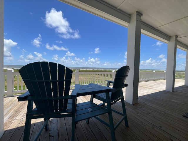 deck featuring a water view and a view of the beach