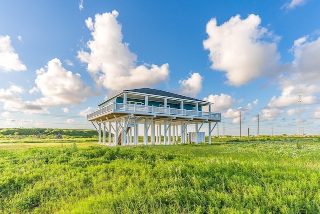 512 Caplen Shores Cir, Gilchrist, TX 77617 - back of property with a wooden deck and roof with shingles
