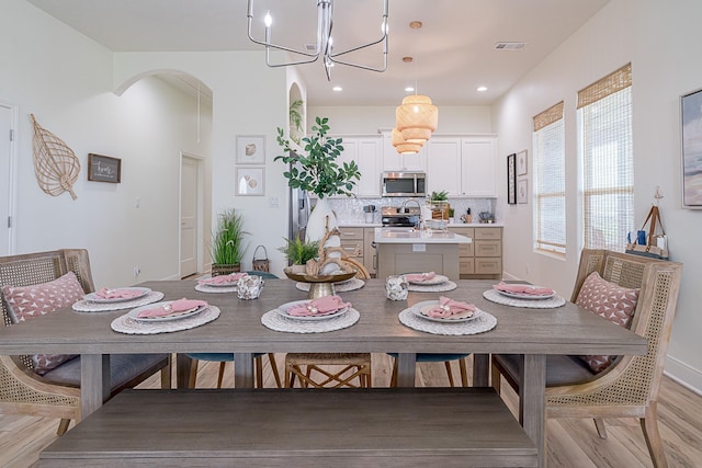 dining space featuring a chandelier and light hardwood / wood-style floors