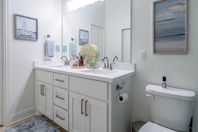 bathroom featuring hardwood / wood-style flooring, vanity, and toilet