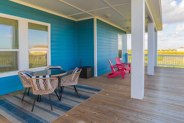 wooden deck featuring outdoor dining area