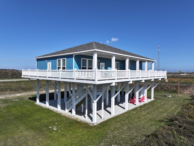 rear view of house featuring a lawn and a wooden deck