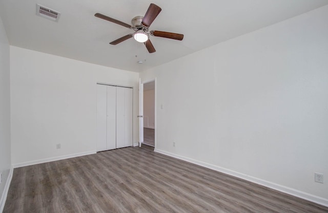 unfurnished room with ceiling fan and dark hardwood / wood-style flooring