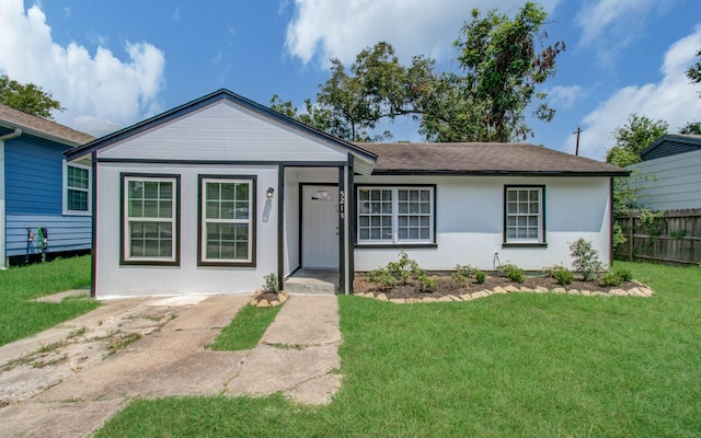 ranch-style home featuring a front yard