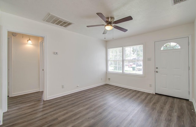 foyer with ceiling fan, dark wood-type flooring, and a textured ceiling