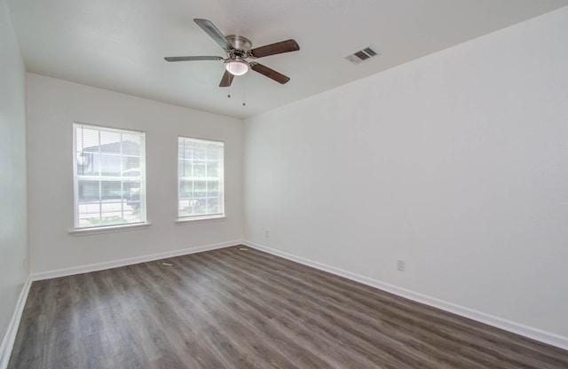 spare room with ceiling fan and dark hardwood / wood-style floors