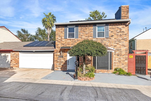 view of property with solar panels and a garage