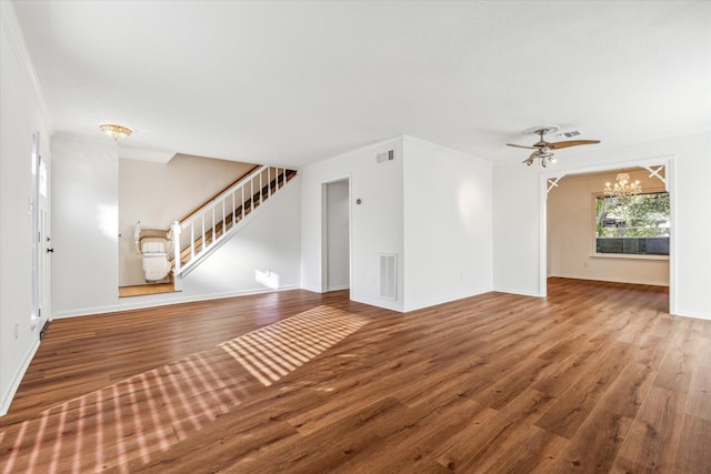 unfurnished living room with wood-type flooring and ceiling fan with notable chandelier