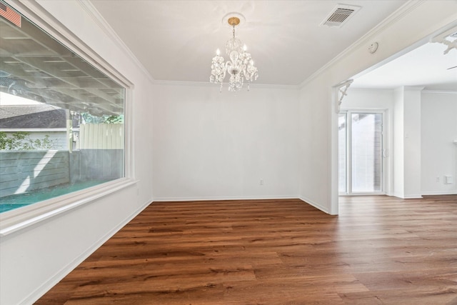 unfurnished dining area featuring wood-type flooring, a notable chandelier, and ornamental molding