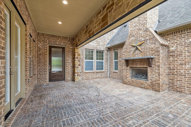 view of patio / terrace with an outdoor brick fireplace