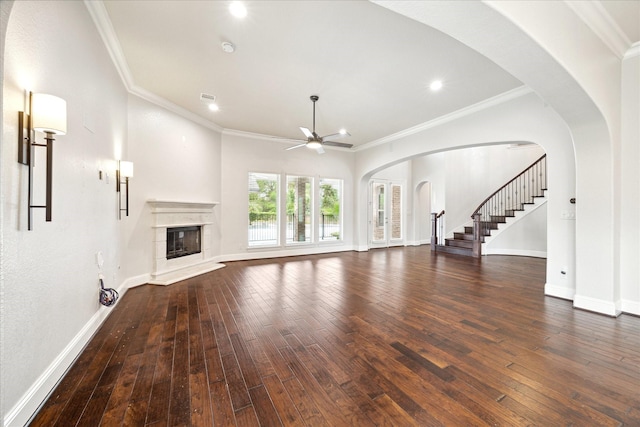 unfurnished living room with ornamental molding, ceiling fan, and dark hardwood / wood-style floors