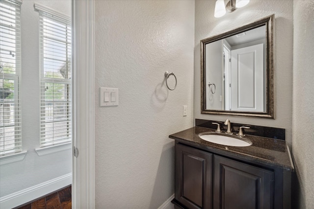 bathroom with vanity and wood-type flooring